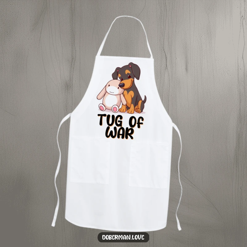 Funny Doberman nudging a large toy on a cooking apron, a humorous and practical gift for dog lovers.
