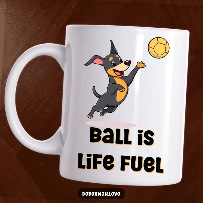 Funny kawaii Doberman mug showing a dog playfully leaping to catch a thrown ball, full of action and cute humor.