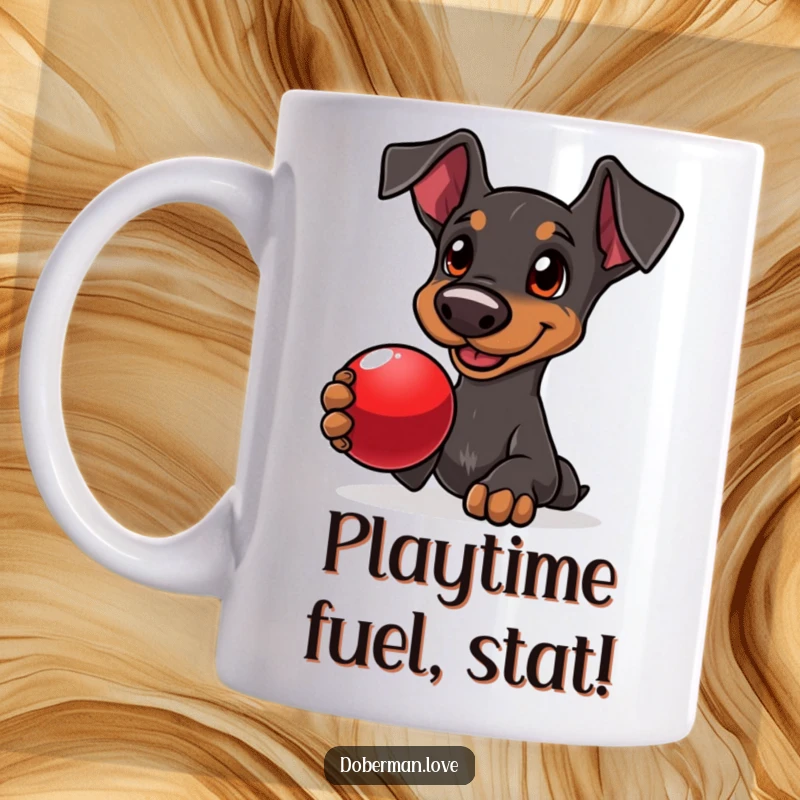 Funny Doberman mug showing a delighted dog with adoring eyes, holding a shiny red ball, ready for fetch.
