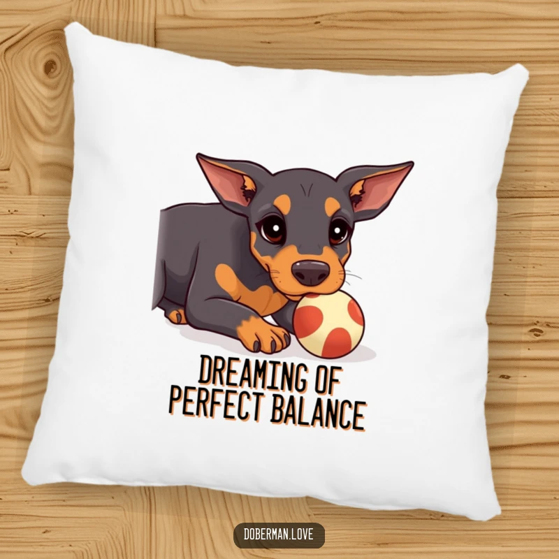 Funny Doberman Pillow with a kawaii doberman puppy focused on balancing a ball on its snout, offering comfort and humor.
