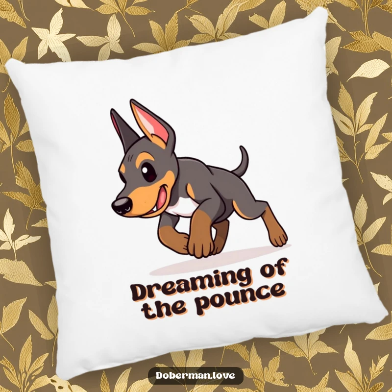 Funny Doberman puppy pillow featuring an energetic puppy in a determined pounce pose, offering comfort and humor with its playful intent.