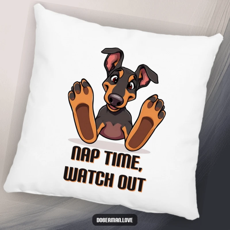 Funny Doberman dog stumbling over large paws on a plush pillow, perfect for cozying up with humor.