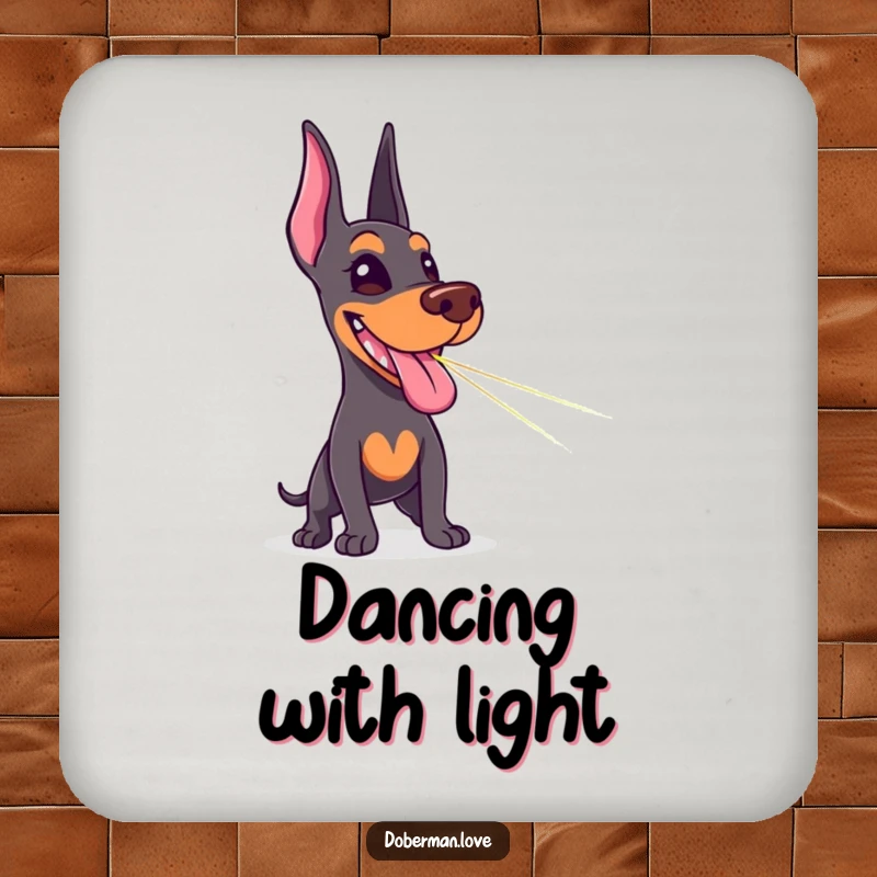 Funny Doberman drink coaster featuring a happy dog tongue out, chasing a laser pointer dot, a humorous addition to any table.
