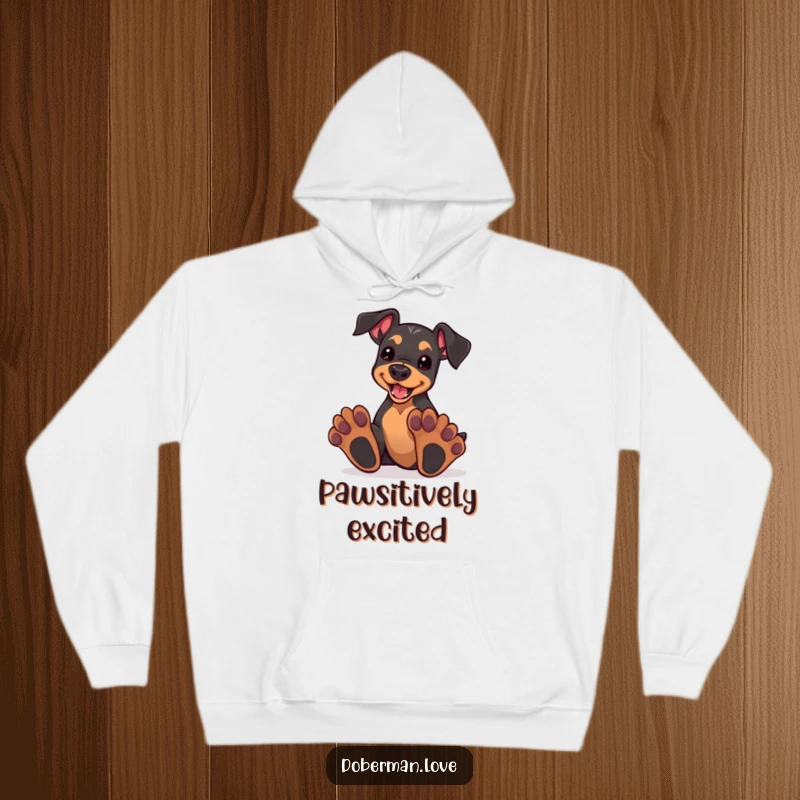 Funny kawaii doberman puppy with oversized paws, enthusiastically playing, depicted on a warm, comfortable hoodie.