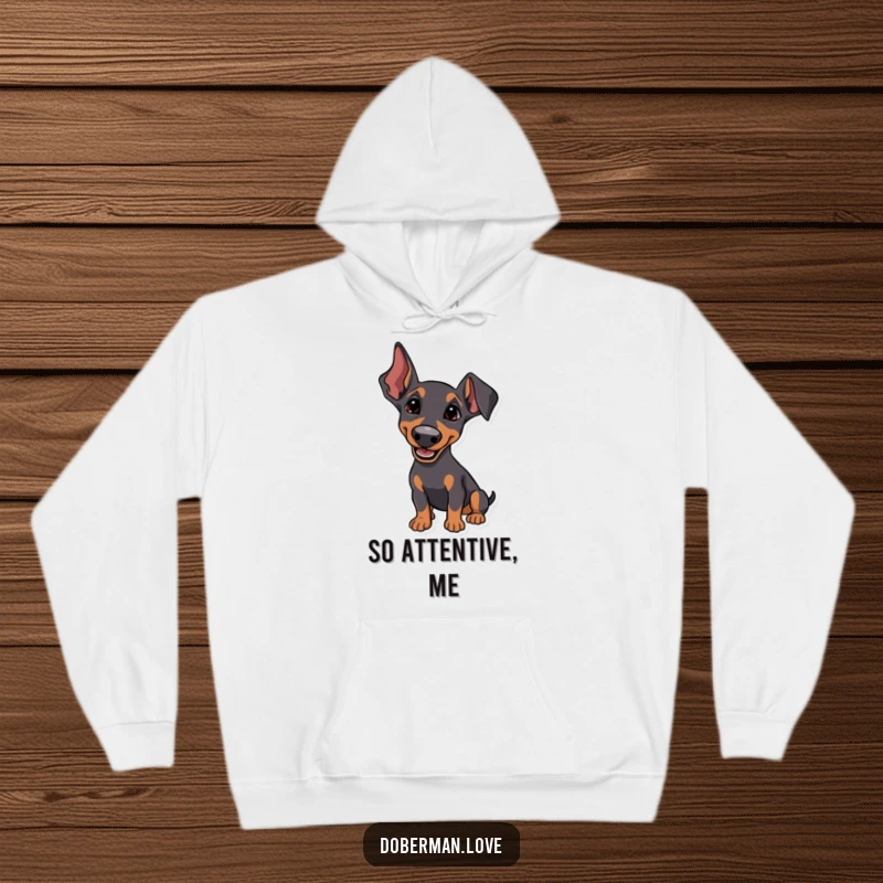 Funny Hoodie depicting a Doberman with perked ears, listening intently with a happy tilt, offering warm comfort and engaged charm.