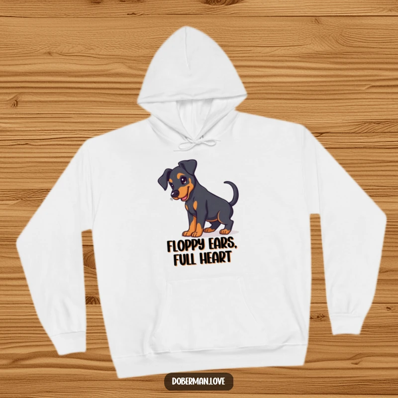 Funny Doberman puppy hoodie with floppy ears and a happy expression, designed for warmth and dog lovers.