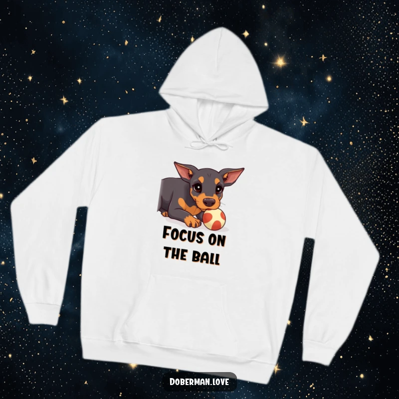 Funny Doberman Hoodie featuring a kawaii doberman puppy concentrating on balancing a ball on its snout, offering warmth and humor.