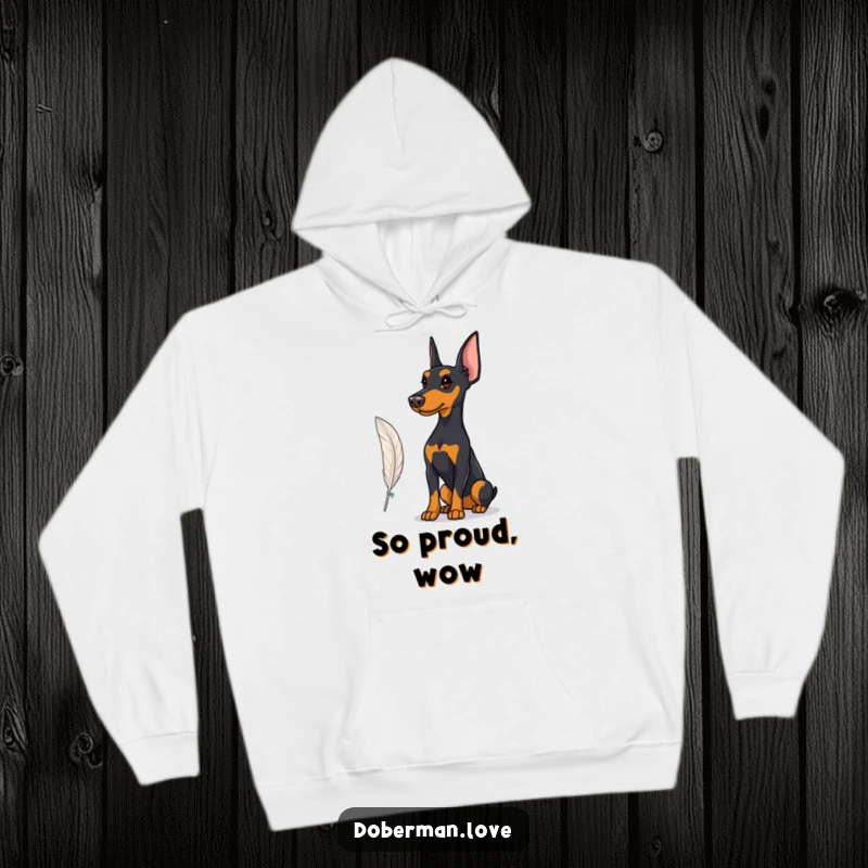 Funny Hoodie depicting a proud Doberman observing a fluttering feather, offering warm comfort with a touch of sophisticated style.