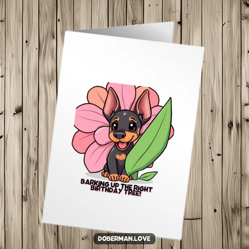 Funny Free Printable Doberman Birthday Card: Adorable cub peeking playfully behind a giant, vibrant flower, ready to celebrate.