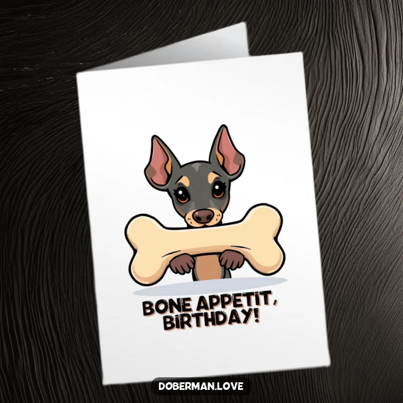 Funny Free Printable Birthday Card: Kawaii Doberman peeking mischievously from behind a huge, stylized bone.
