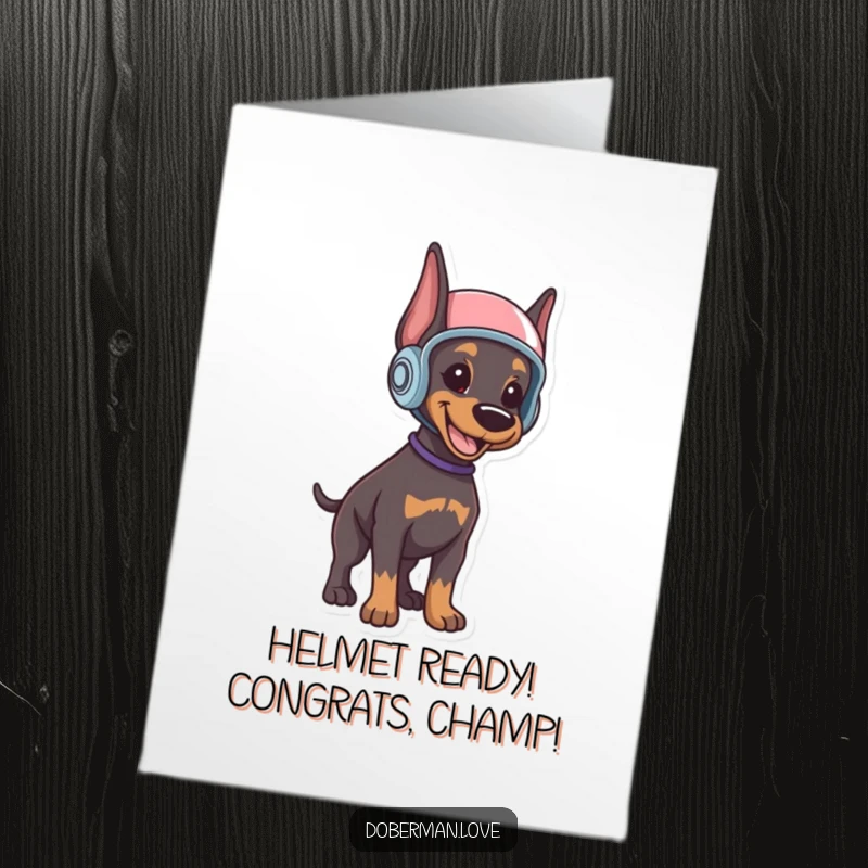 Funny free printable congratulations card showing a smiling Doberman puppy wearing a small helmet, standing alert and ready.