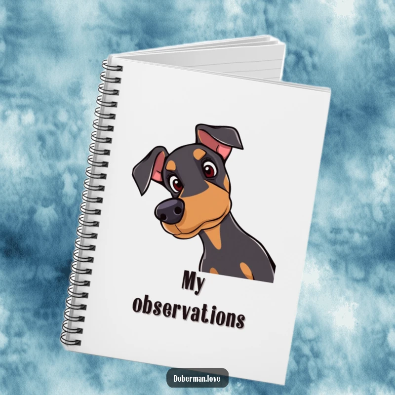 Funny Doberman notebook with a curious dog tilting its head with attentive eyes on the cover, ideal for notes and doodles.