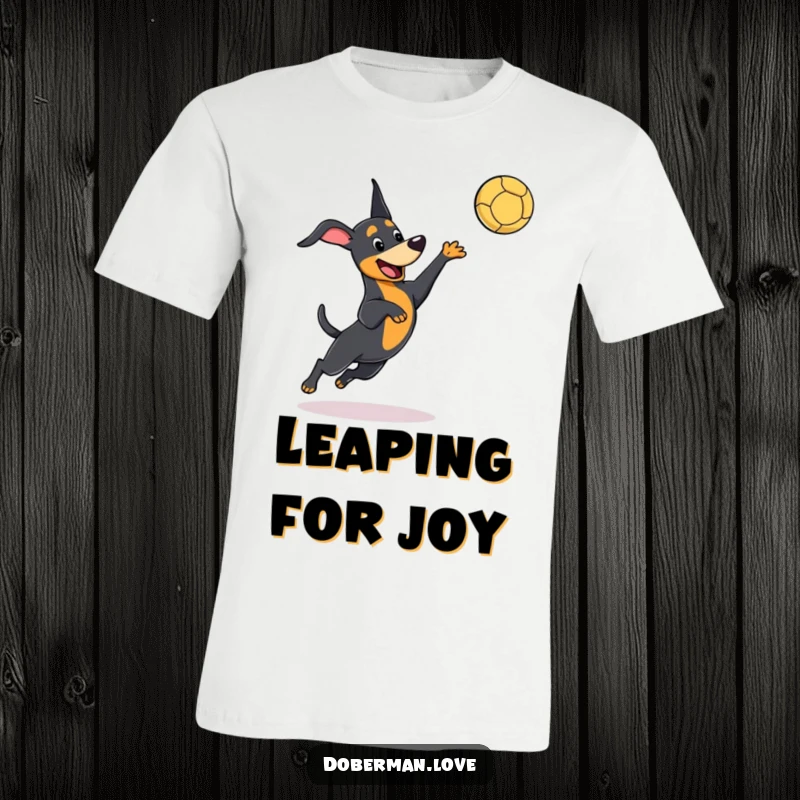 Funny kawaii Doberman t-shirt with a dog playfully leaping to catch a ball, depicting energetic fun and cute action.