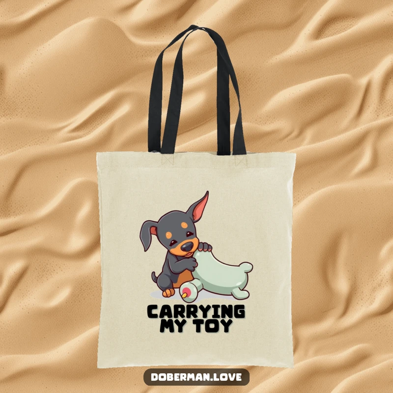 Funny Doberman tote bag with a tiny dog playfully wrestling with an oversized toy chew, perfect for carrying daily items with doggy determination.