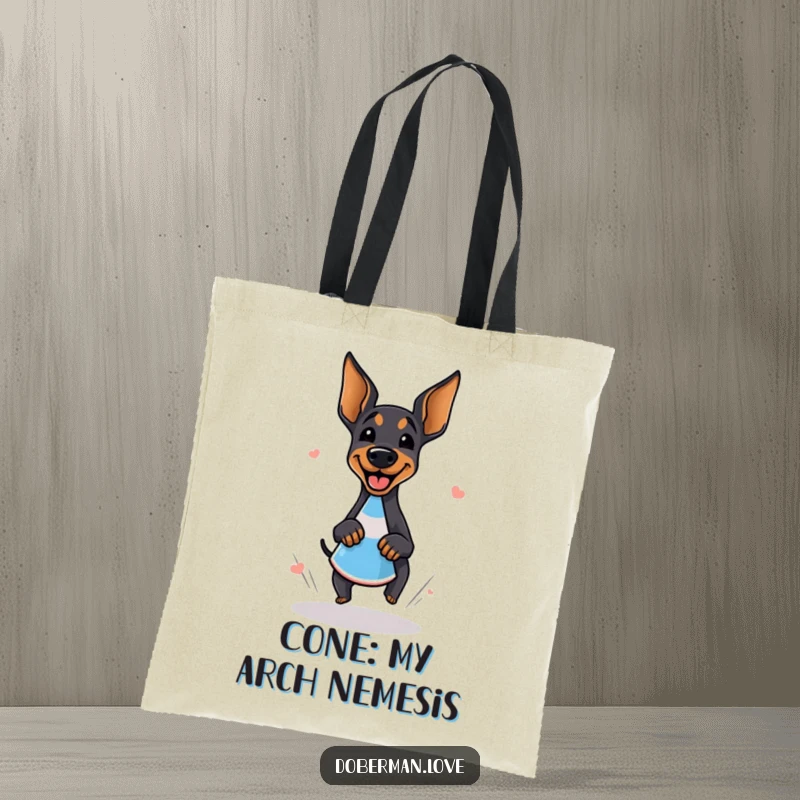 Funny doberman tote bag with a design of a giggling dog doing a happy zoomie around a cone, perfect for dog lovers.