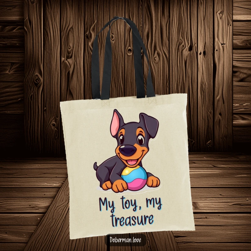 Funny Doberman Tote Bag: Cheerful dog nudging a colorful toy, a humorous and practical accessory.