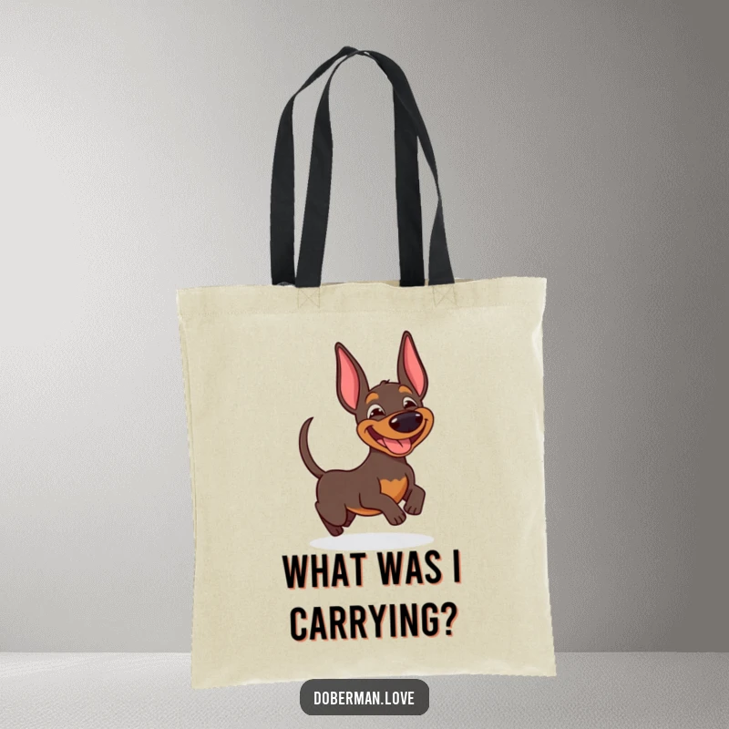Funny Doberman tote bag showcasing a gleeful dog with a goofy expression, adorably chasing its own wagging tail.
