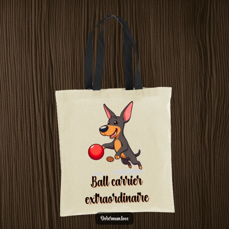 Funny Doberman Tote Bag: Playful Doberman leaping to catch a red ball, a humorous and practical tote for dog owners.